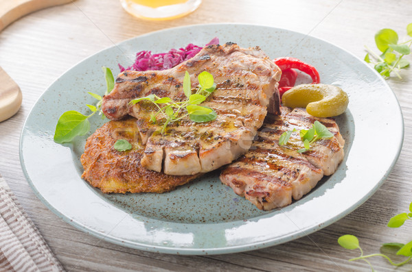 Grilled pork chops with herbs and garlic, potato pancakes Stock photo © Peteer