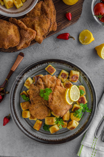 Schnitzel original with lemon and gnocchi fried Stock photo © Peteer