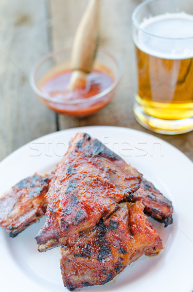 Spareribs on grill with hot marinade, czech beer Stock photo © Peteer