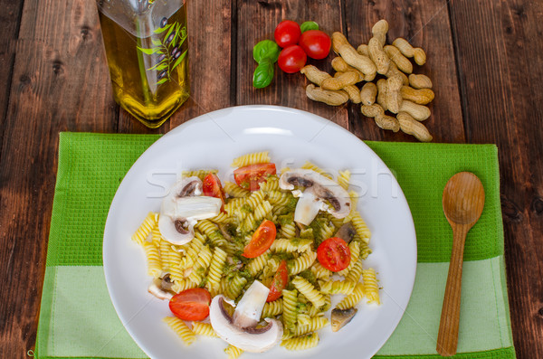 Stock photo: Pasta with basil pesto, nuts and mushrooms