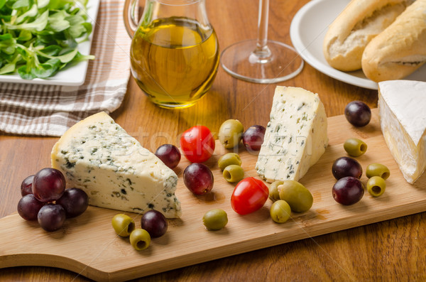 Delicious blue cheese with olives, grapes and salad Stock photo © Peteer