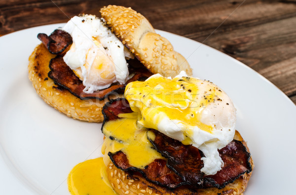 Benedict eggs with crispy bacon and hollandaise sauce on toasted Maffin Stock photo © Peteer