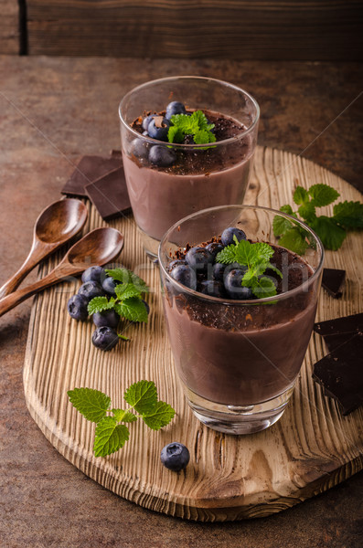 Chocolate pudding with berries and herbs Stock photo © Peteer