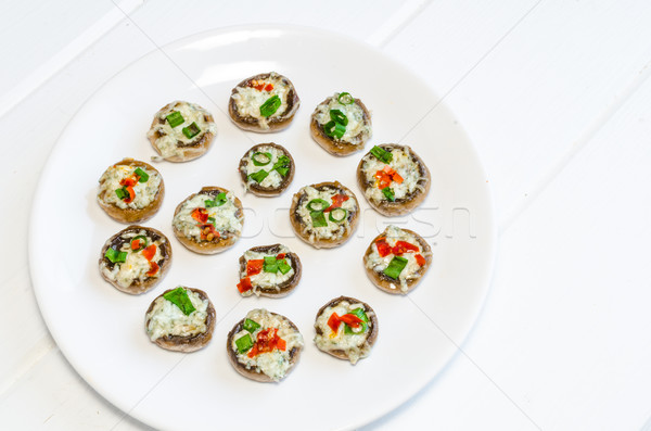 Baked muhrooms with blue cheese, red pepper and spring onion Stock photo © Peteer