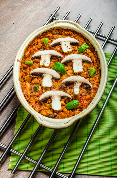 Chicken baked with rice, mushrooms and tomatoes Stock photo © Peteer