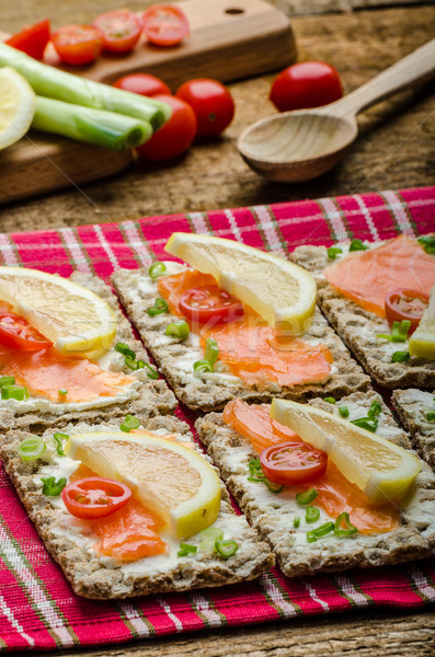 Bio healthy food - kneckebrot spread cheese with smoked salmon and cherry tomatoes Stock photo © Peteer