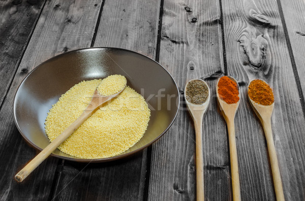 Spice on spoon with bowl of couscous Stock photo © Peteer