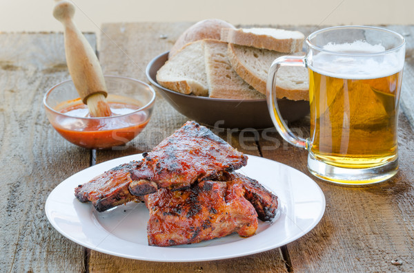 Spareribs on grill with hot marinade, czech beer Stock photo © Peteer
