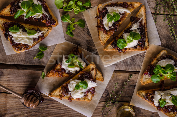 Rustic toast with caramelized onion and goat cheese Stock photo © Peteer