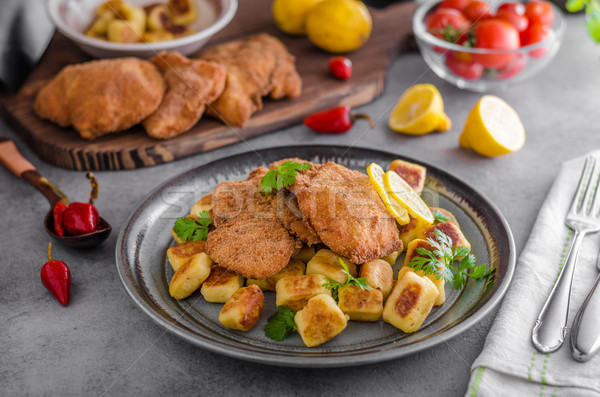 Schnitzel original with lemon and gnocchi fried Stock photo © Peteer