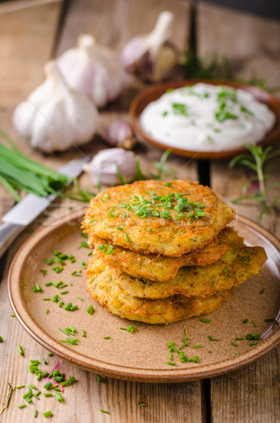 Potato pancakes with sour cream Stock photo © Peteer