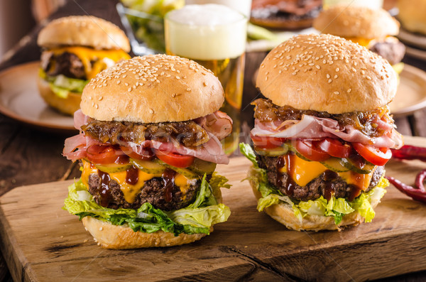 Homemade beef burger, caramelized onion, bacon and beer Stock photo © Peteer