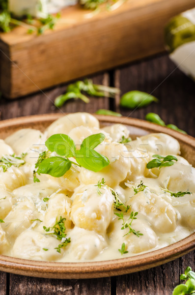 Cheese gnocchi with blue cheese sauce and galic Stock photo © Peteer