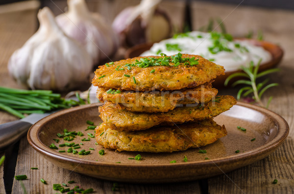 Potato pancakes with sour cream Stock photo © Peteer