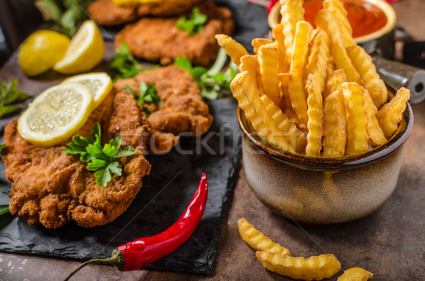 Schnitzel with fries, salad and herbs Stock photo © Peteer