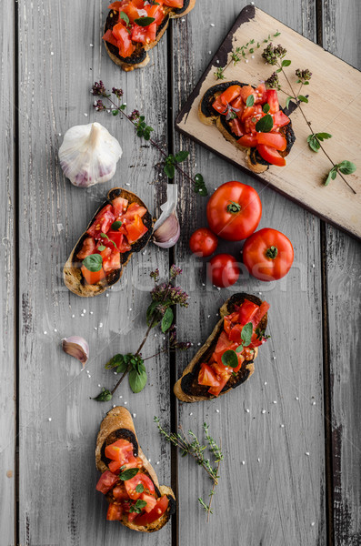 Bruschetta with tomatoes, garlic and herbs Stock photo © Peteer