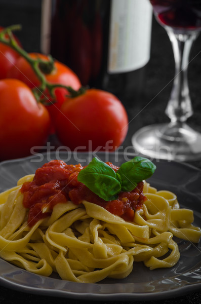 Stock photo: Semolina pasta with spicy tomato salsa, garlic and basil