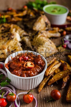 Sticky chicken with red hot dip Stock photo © Peteer