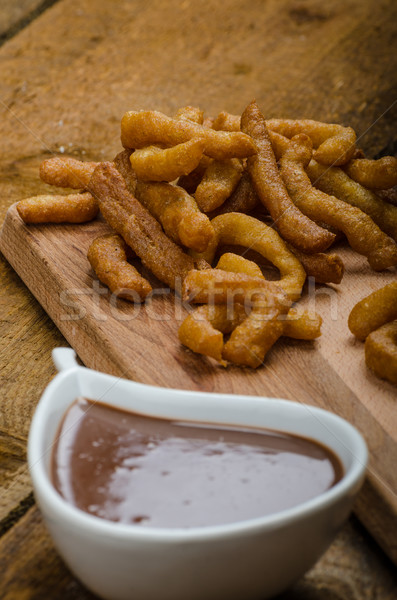 Churros with chocolate dip - Streed food, deep fried Stock photo © Peteer