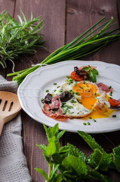 Fried eggs with ham and herbs Stock photo © Peteer