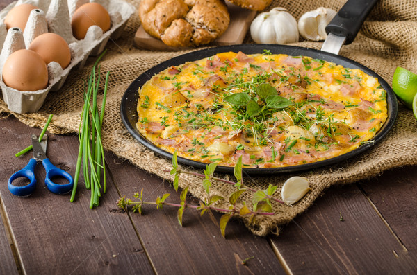 Egg omeletta with ham and herbs Stock photo © Peteer