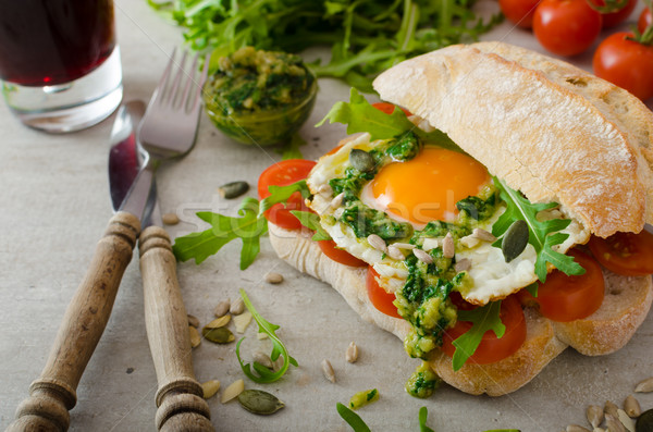 Ciabatta with fried egg, tomatoes and pesto Stock photo © Peteer