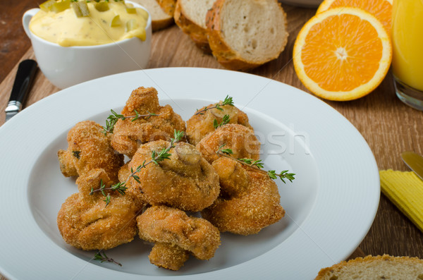 Breaded fried mushrooms with juice Stock photo © Peteer