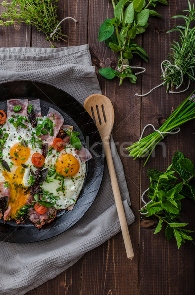 Fried eggs with ham and herbs Stock photo © Peteer