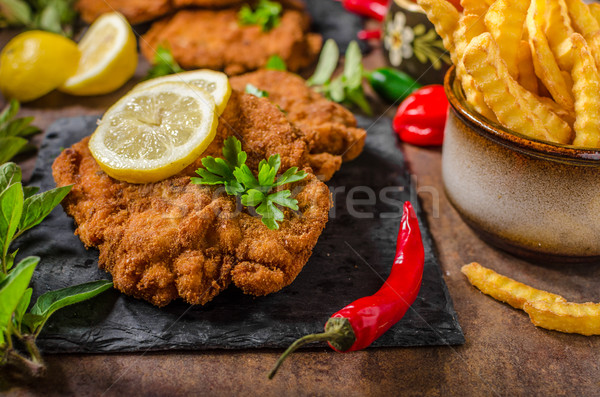 Stock photo: Schnitzel with fries, salad and herbs
