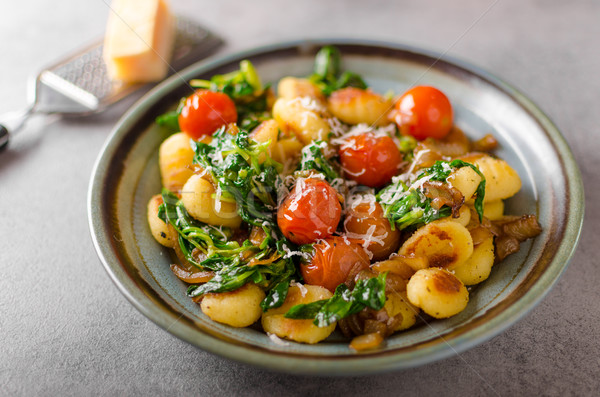 Gnocchi with spinach, garlic and tomatoes Stock photo © Peteer