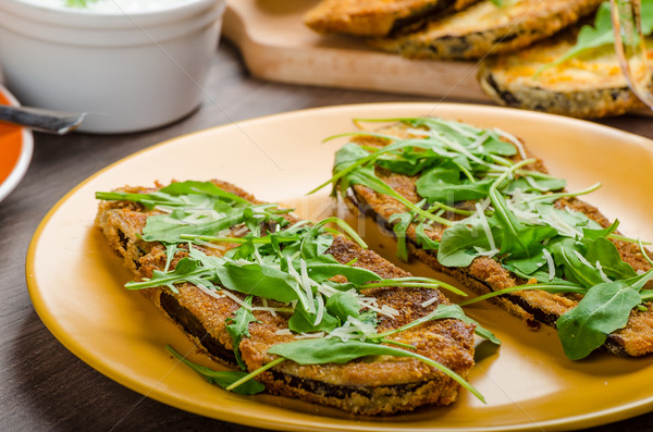 Breaded eggplant parmesan and arugula Stock photo © Peteer