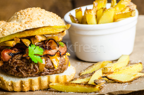 Beef burger with bacon, cheddar, homemade fries Stock photo © Peteer