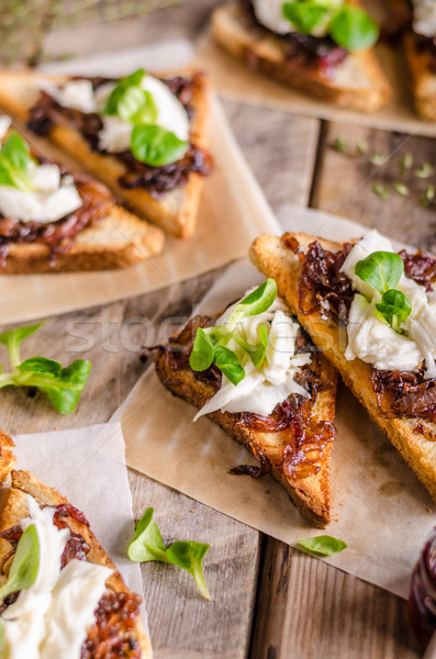 Rustic toast with caramelized onion and goat cheese Stock photo © Peteer