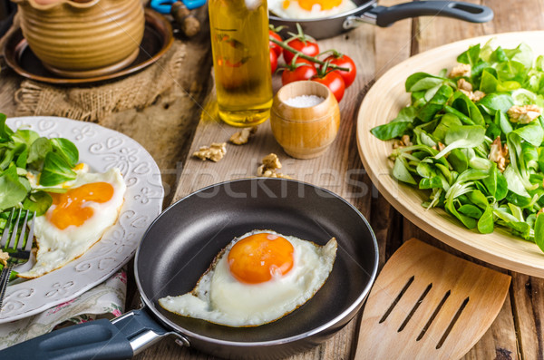 Fried eggs with salad and nuts Stock photo © Peteer