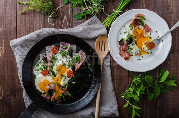 Fried eggs with ham and herbs Stock photo © Peteer