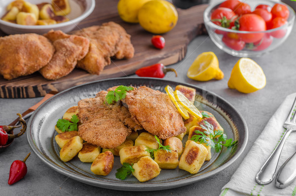 Schnitzel original with lemon and gnocchi fried Stock photo © Peteer