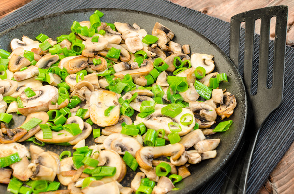 Fried mushrooms with spring onion on pan Stock photo © Peteer