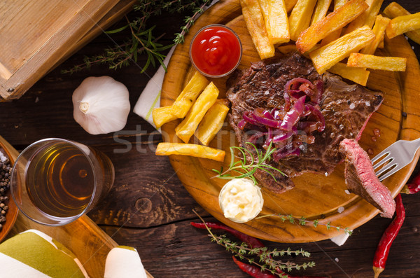 Stock photo: Beef steak with homemade french fries, beer and tartar sauce
