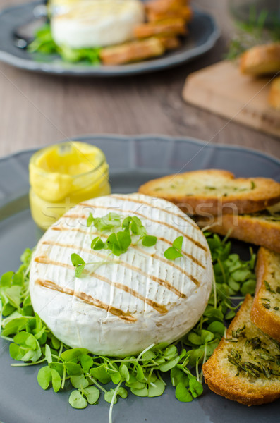 Grilled camembert with herbs, baquettes Stock photo © Peteer