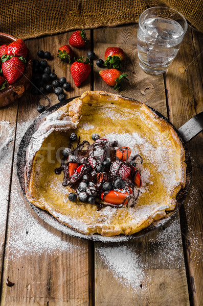 Dutch Baby Pancakes with berries and chocolate Stock photo © Peteer