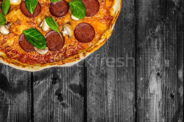 Stock photo: Rustic pizza with salami, mozzarella and spinach