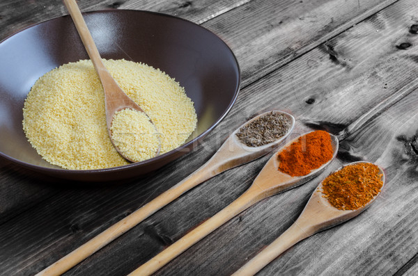 Spice on spoon with bowl of couscous Stock photo © Peteer