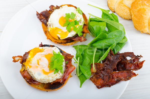 Eggs benedict with bacon and spinach Stock photo © Peteer