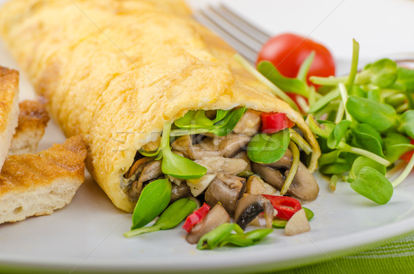 Stock photo: Omelette stuffed with mushrooms and microgreens