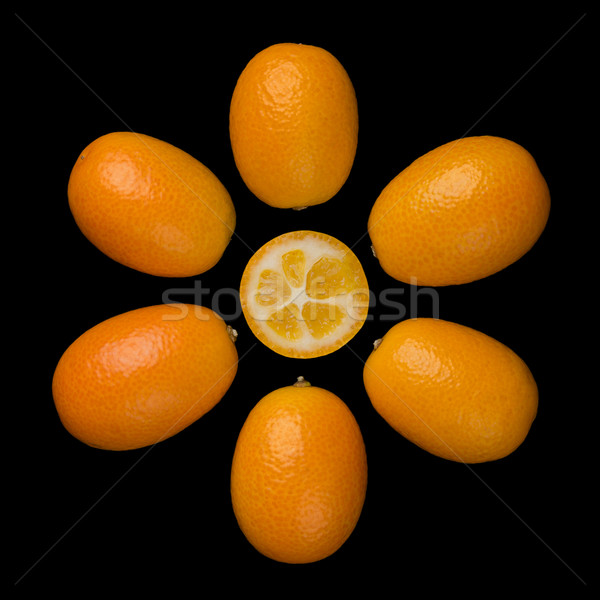 Oval Kumquats Forming A Sun Symbol On Black Background Stock photo © PeterHermesFurian