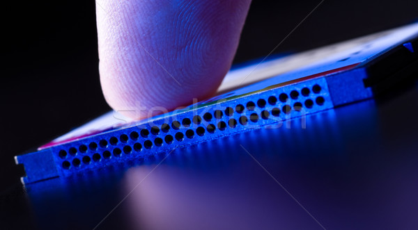 finger on flash card in blue light closeup Stock photo © PetrMalyshev