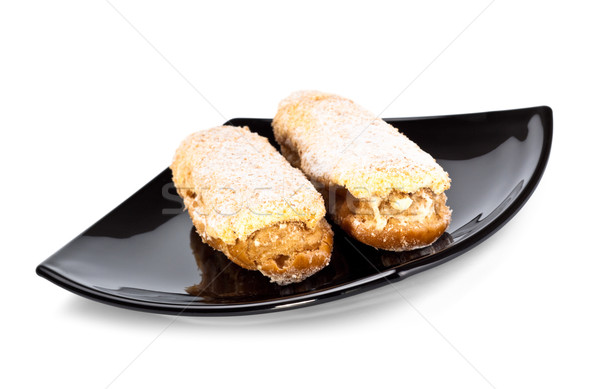 Stock photo: two eclairs on black dish