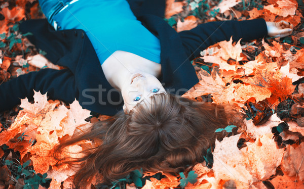 Girl Lying in Autumn Leaves Stock photo © PetrMalyshev