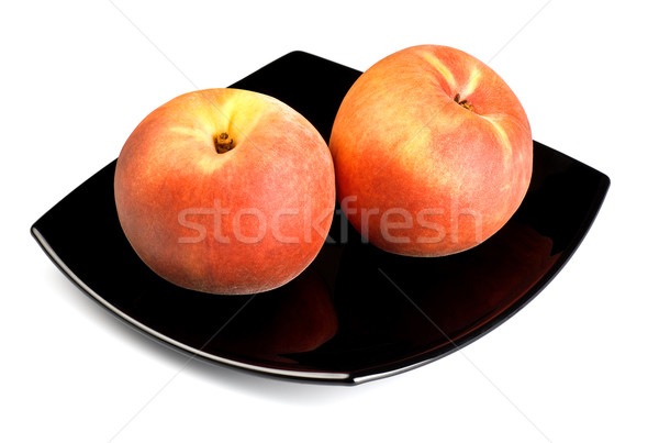 red peaches on black dish Stock photo © PetrMalyshev