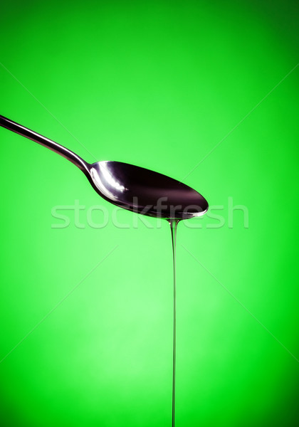 oil spill out of spoon Stock photo © PetrMalyshev